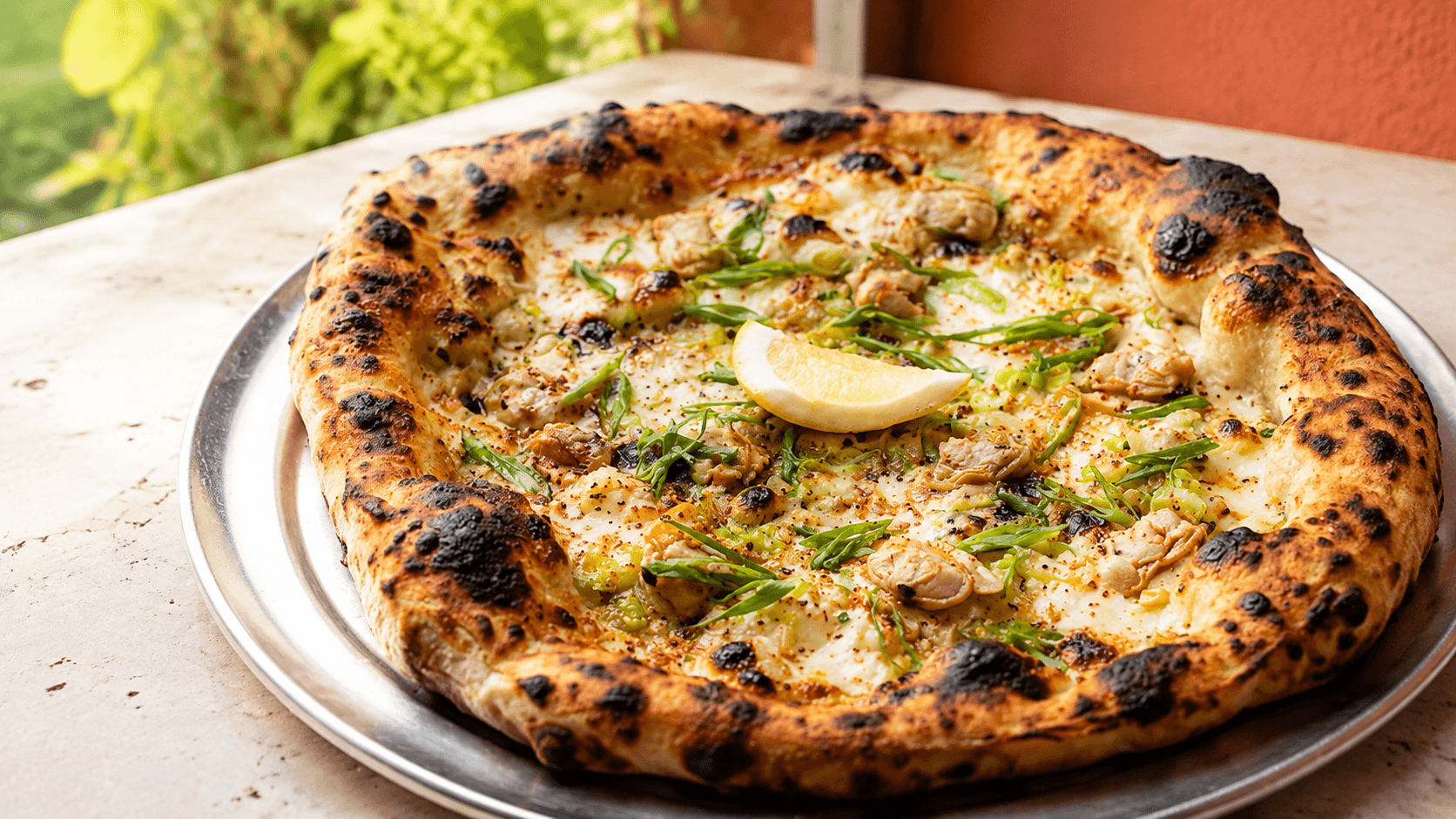 A neo-Neapolitan pizza beside an aperitivo cocktail at ViceVersa
